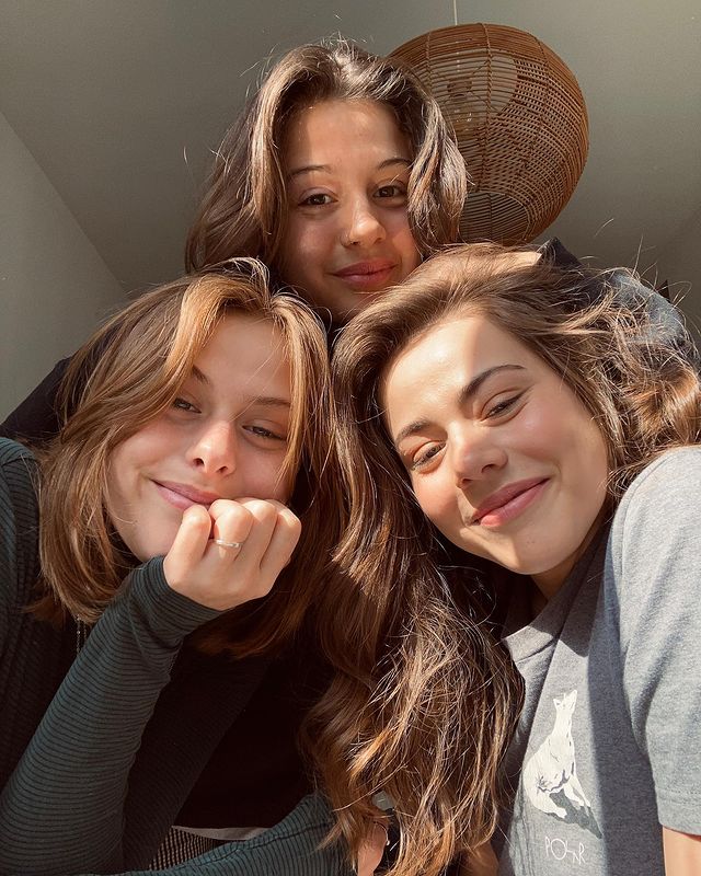 Susan Radder with her sisters in black and grey dresses.